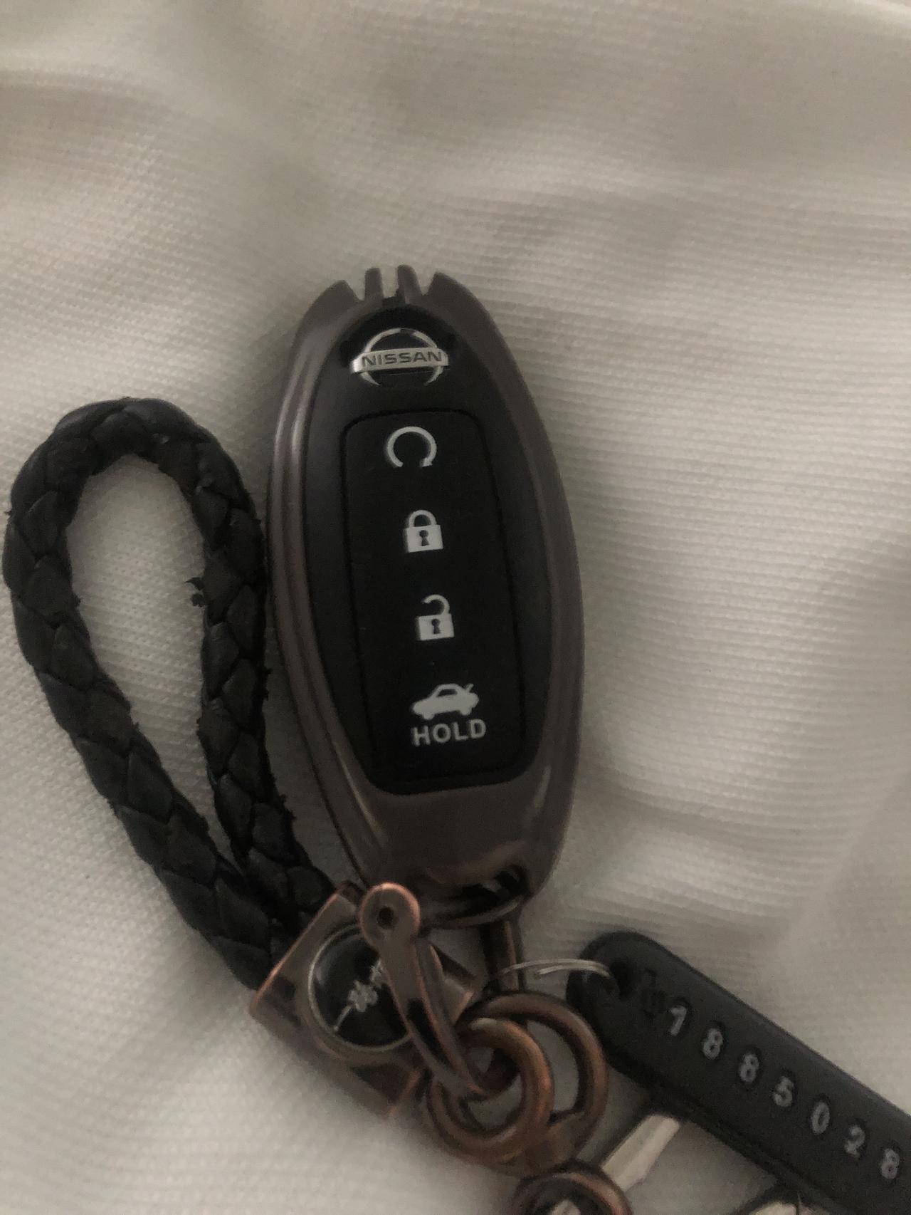 日产轩逸 钥匙的第一个按键是什么功能啊