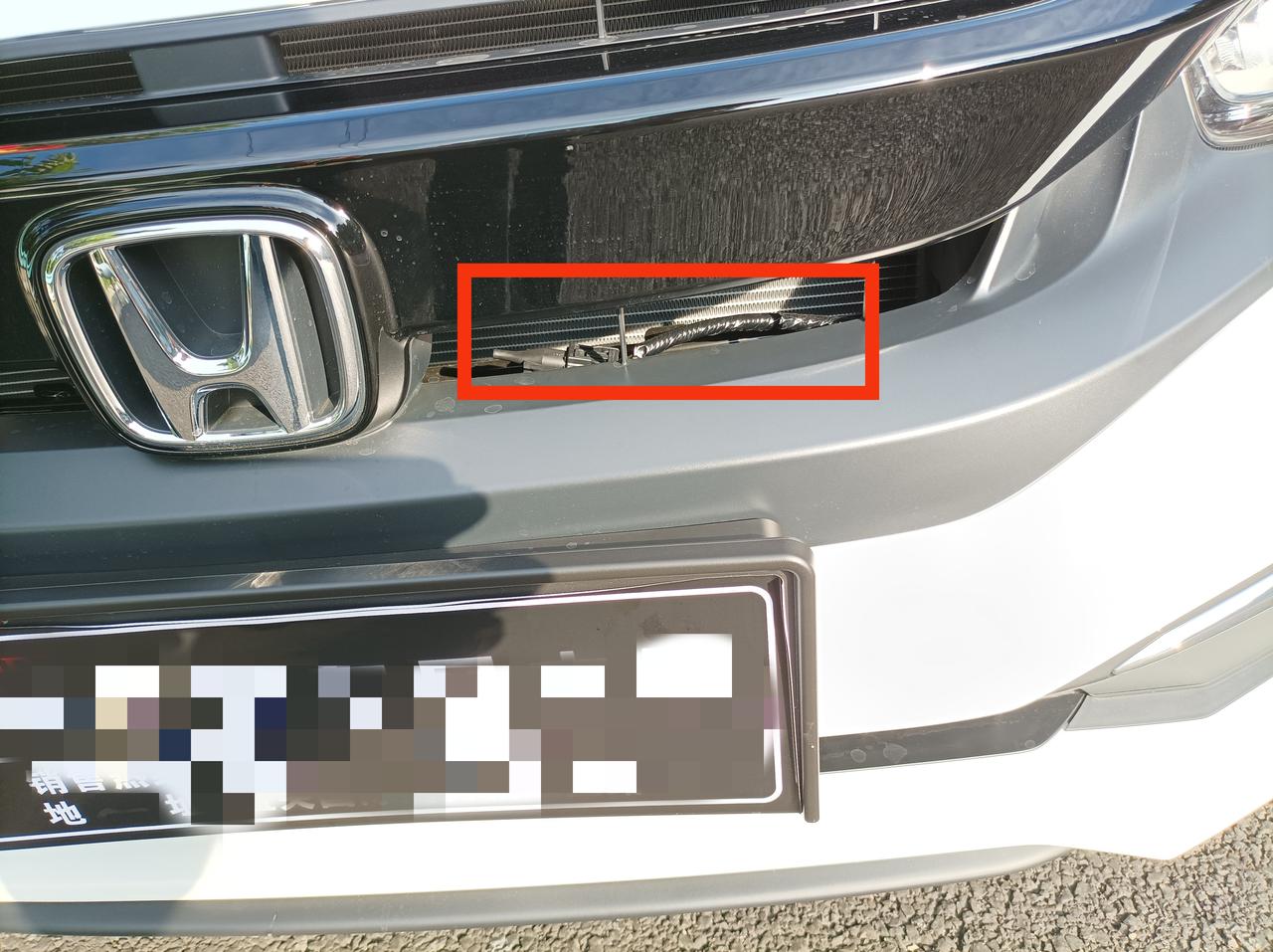 本田思域 今天刚提的车，回家下高速，才看到前面车标右边发动机舱里有跟线束，感觉很突兀，这是不是有什么问题？